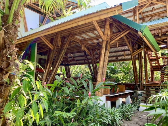 Living area with views of pool and gardens 