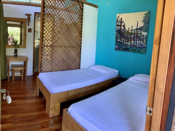 Wooden and bamboo decor inside eco-lodge room 
