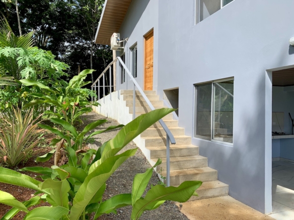 Porch with seating and views of forest and gardens 