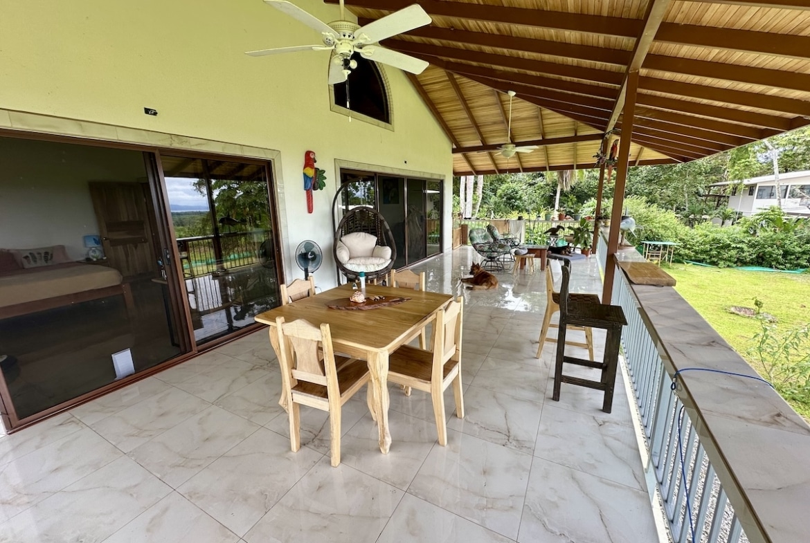 Dining space overlooking lush tropical forest in Puerto Jiménez