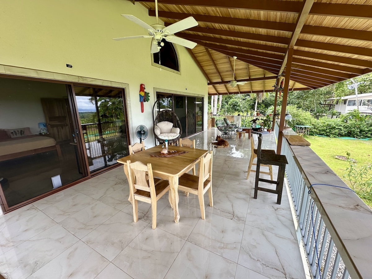 Dining space overlooking lush tropical forest in Puerto Jiménez