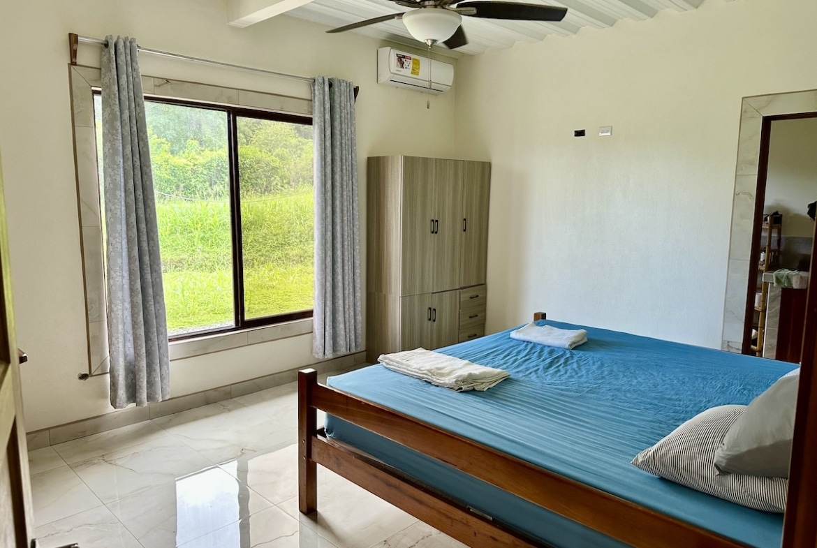 Master suite in Puerto Jiménez duplex with large windows