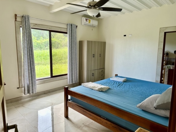 Master suite in Puerto Jiménez duplex with large windows