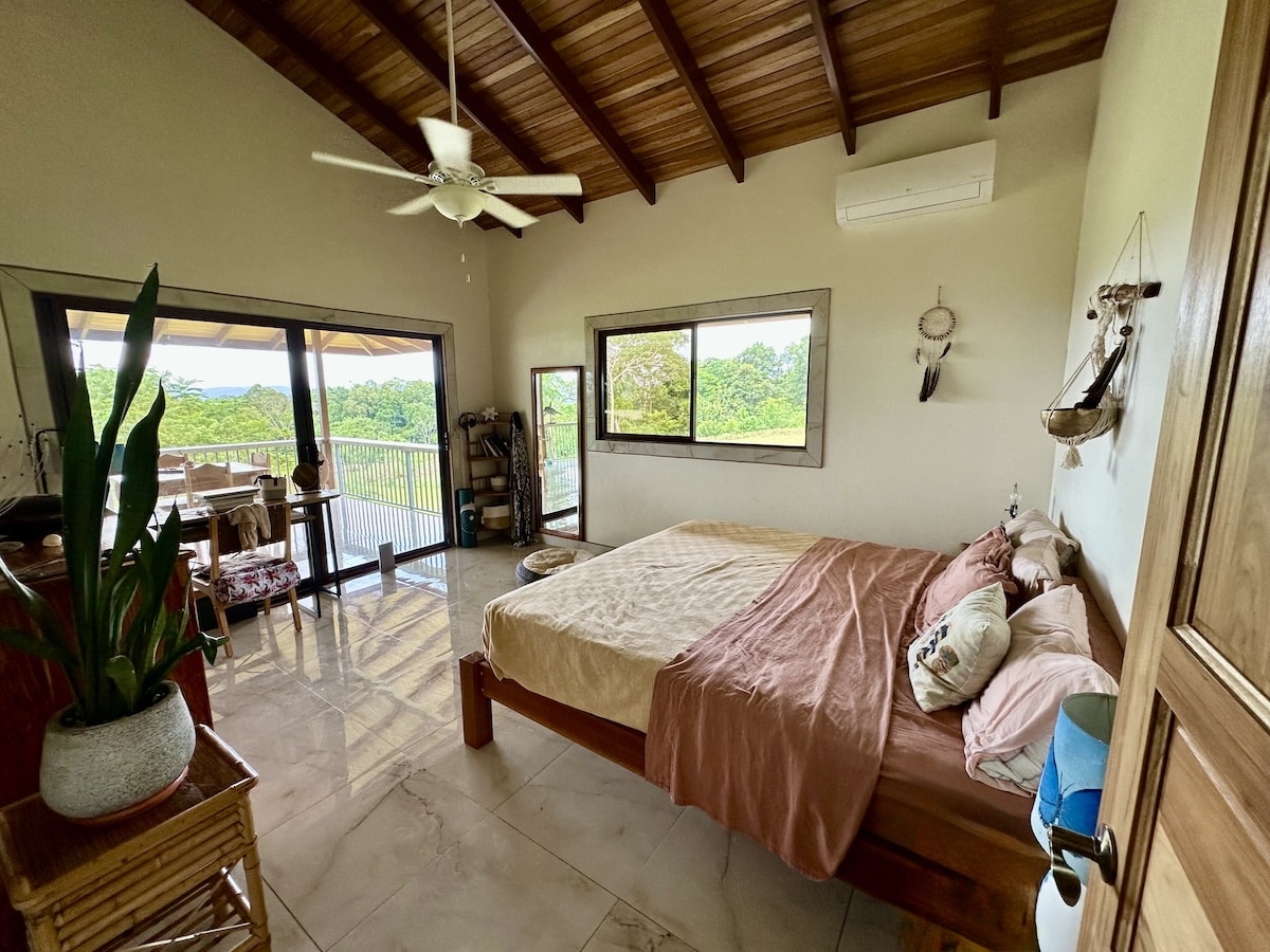 Guest bedroom with modern furnishings inside two-story duplex near Puerto Jiménez, Costa Rica.