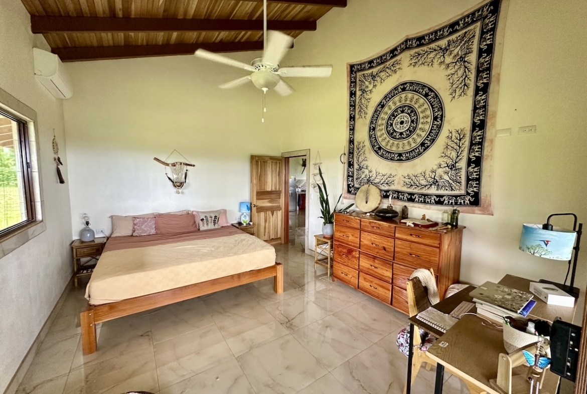 Peaceful master bedroom in Osa Peninsula duplex overlooking tropical forest.