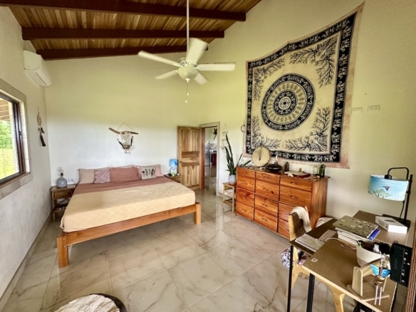 Peaceful master bedroom in Osa Peninsula duplex overlooking tropical forest.