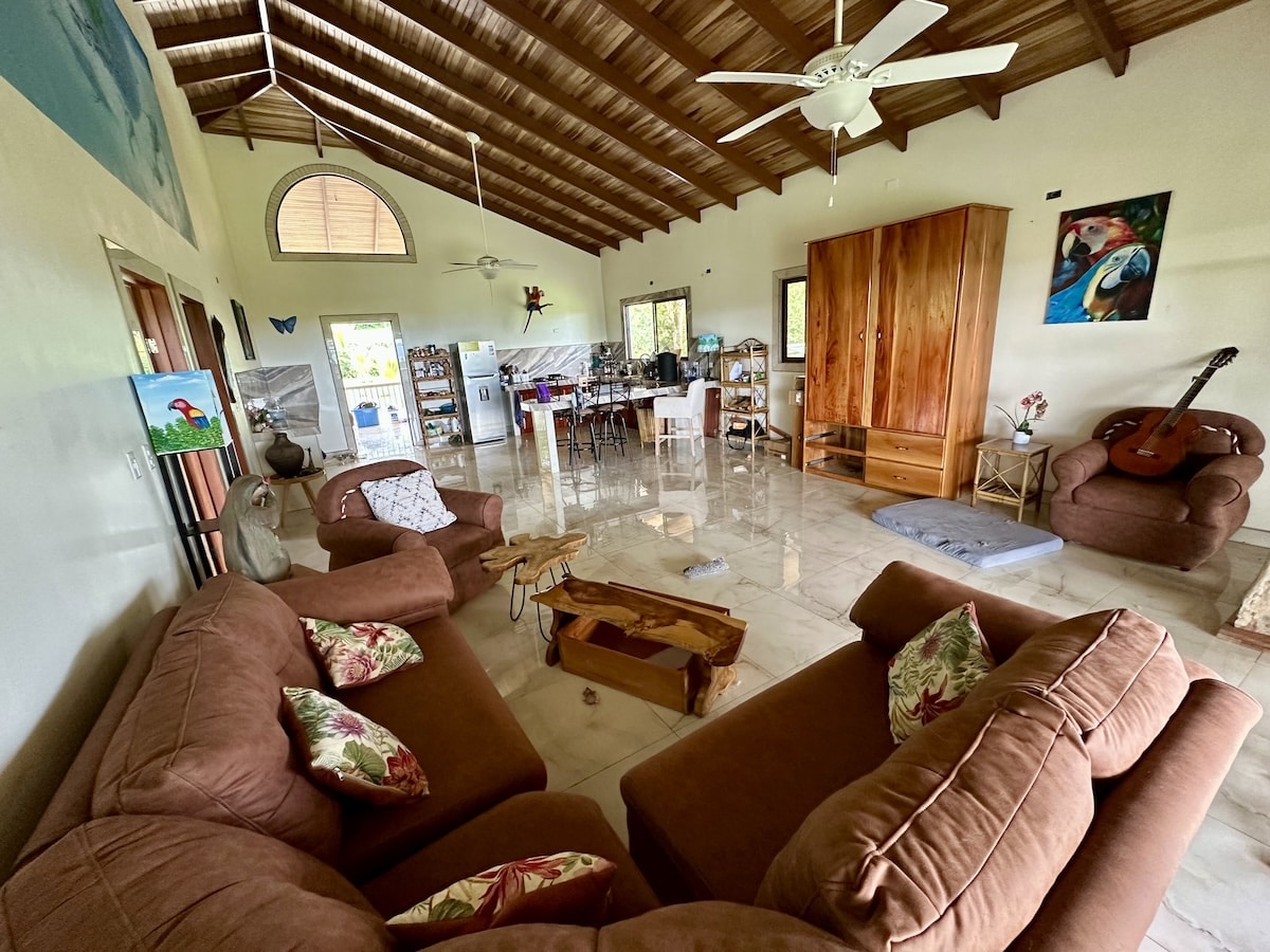 Tropical-inspired living room inside two-story duplex near Corcovado National Park, Osa Peninsula.